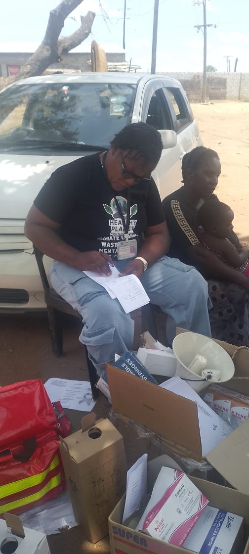 Volunteer supporting a household health activity